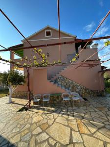 a house with two stools and a staircase in front at Telis Apartments One in Roda