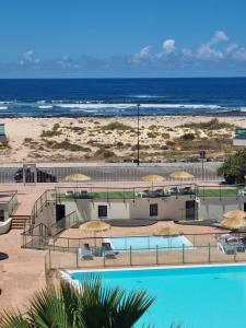 a resort with a swimming pool and a beach at Azotea de Cotillo in Cotillo