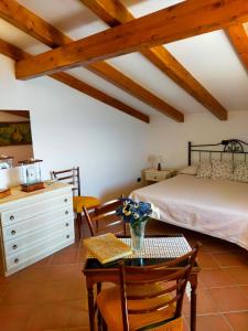 a bedroom with a bed and a table and a desk at Casa Vacanze Nonno Aldo in Minori