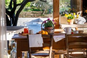 a table with a plate of fruit and juice on it at B&B Dimora Castello in Galatone
