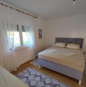 a white bedroom with a bed and a window at Herzegovinian Hobbiton in Stolac +10 photos