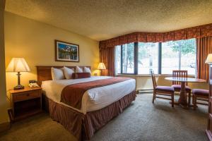 a hotel room with a bed and a large window at The Grand Lodge, A Vail Resorts Property in Mount Crested Butte +102 photos