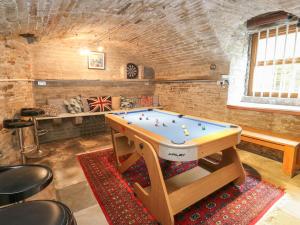 a ping pong table in the middle of a room at The Old Post Office at Holmfirth in Holmfirth