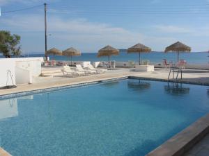 a swimming pool with a view of the ocean at Galatis Beach Hotel in Aliki