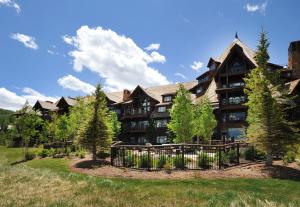 a large building with trees in front of it at Bachelor Gulch Village in Avon