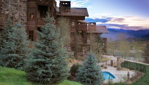 a large house with trees in front of it at Bachelor Gulch Village in Avon