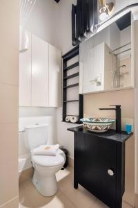 a bathroom with a white toilet and a sink at Hoża 62 Apartment in Warsaw +14 photos