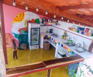 a kitchen with a sink and a refrigerator at Nasu Lodge in La Cruz