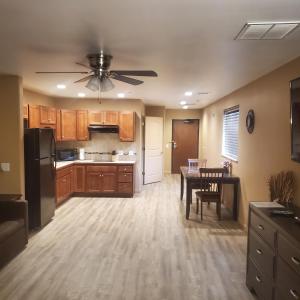 a kitchen with a table and a ceiling fan at Terrace Park Inn in Fort Morgan