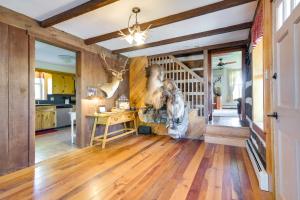 a kitchen with wooden floors and a staircase in a house at Rustic Wellsville Home - 5 Mi to Roundtop Mountain 