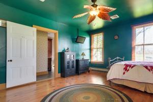 a bedroom with green walls and a ceiling fan at Rustic Wellsville Home - 5 Mi to Roundtop Mountain in Wellsville +23 photos