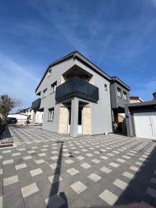 a large white building with a roof at Apartmani Frane in Vir