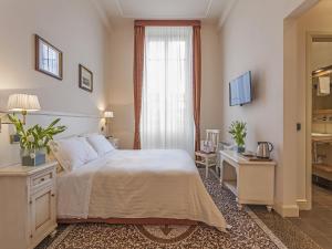 Säng eller sängar i ett rum på Hotel Astro Mediceo
