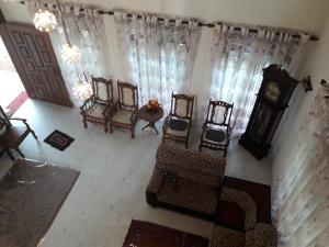 an overhead view of a living room with chairs and a clock at Pearl Villa,Mirissa in Kamburugamuwa