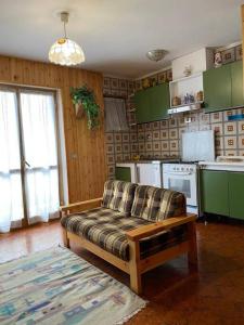 a living room with a couch in a kitchen at Appartamento Cerreto Laghi in Cerreto Laghi