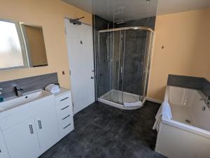 a bathroom with two sinks and a shower at The Cairns Leven Fife in Fife