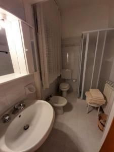 a white bathroom with a sink and a toilet at Agriturismo Campo Contile in Chianciano Terme