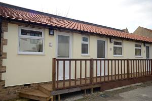 a house with a wooden deck in front of it at The Bell P.H. in Brandon