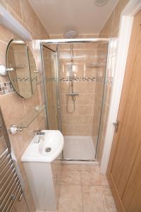 a bathroom with a shower and a toilet and a sink at The Bell P.H. in Brandon