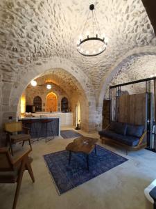 a living room with a couch and a table at TUĞMANER Small House AJAR in Mardin