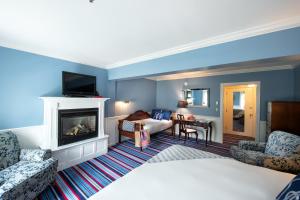 a hotel room with a bed and a fireplace at Kennebunkport Inn in Kennebunkport