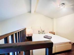 a small bedroom with a bed and a staircase at Elegant modern loft in Kryopigi in Kriopigi