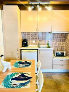 a kitchen with a table with chairs and a sink at Elegant modern loft in Kryopigi in Kriopigi