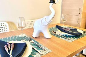 a table with plates and glasses on a wooden table at Elegant modern loft in Kryopigi in Kriopigi