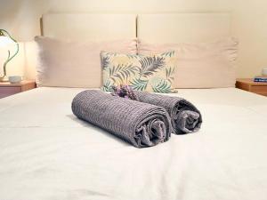 a bed with two towels on top of it at Elegant modern loft in Kryopigi in Kriopigi