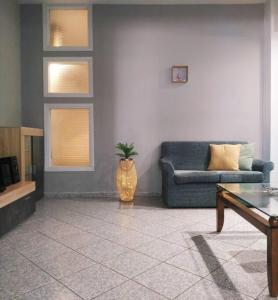 een woonkamer met een bank en een tafel bij Modern & Comfortable, Single Floor Apartment***** in Heraklion