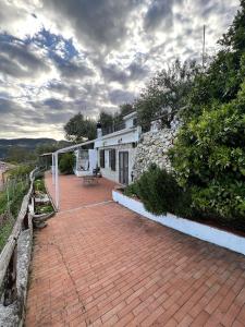 a brick walkway in front of a house with a building at Casa Sancio in Spotorno