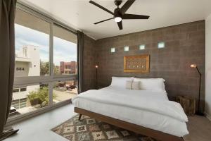 a bedroom with a large bed and a large window at Tempe Lofts in Tempe +66 photos