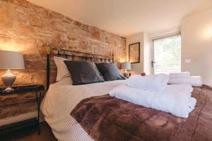 a bedroom with a large bed with white pillows at The Hayloft, Pillar Box Farm Cottages in Ludlow