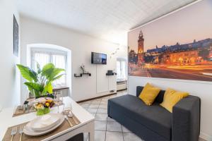 a living room with a couch and a table at Centro storico · Leonardo House in Bergamo