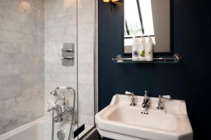 a bathroom with a sink and a shower and a tub at The Bottle & Glass Inn - Garden View - Room 1 in Henley on Thames
