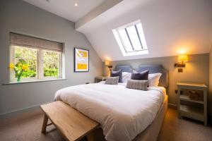 a bedroom with a large white bed with a skylight at The Bottle & Glass Inn - Garden View - Room 1 in Henley on Thames