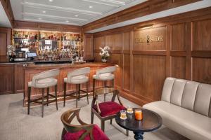 a bar with a couch and chairs in a room at Portland Regency Hotel & Spa in Portland