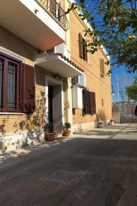 an empty street in front of a building at Casa Vacanze Alla Maison in Fiumicino