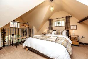 a bedroom with a large bed in a attic at The Stocks Barn in Wellingore