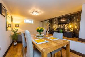 a dining room with a wooden table and chairs at The Stocks Barn in Wellingore