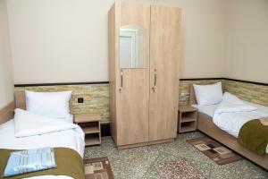 Ένα ή περισσότερα κρεβάτια σε δωμάτιο στο ASA Hotel