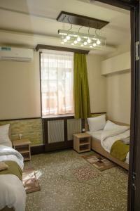 Ένα ή περισσότερα κρεβάτια σε δωμάτιο στο ASA Hotel