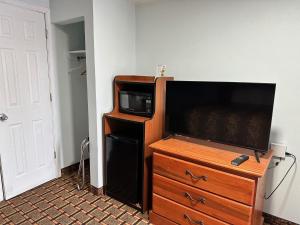 a flat screen tv sitting on a dresser in a room at Bestway Inn in Muncie