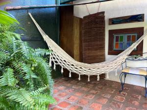 a hammock hanging from the side of a house at Oca House in Búzios