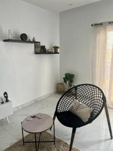a chair and a table in a living room at 2br modern apartment in Almadies in Dakar