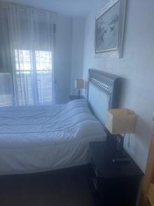 a blue room with a bed and a window at Apartamento Gloria Patricia in Alcantarilla