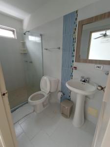 a bathroom with a toilet and a sink and a shower at Hotel Palermo Sincelejo in Sincelejo