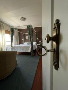 a bedroom with a bed and a door with a mirror at Hostal El Botero in Monreal del Campo