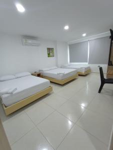 Postel nebo postele na pokoji v ubytování Hotel Palermo Sincelejo