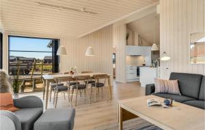 a living room and kitchen with a table and chairs at Pet Friendly Home In Hjrring With Wifi in Hjørring